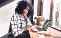 Business casual lifestyle.Beautiful african american woman working in a beautiful cozy office near the window looking at camera Royalty Free Stock Photo