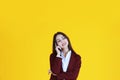 Business Caucasian woman in red suit smiling and thinking for good idea isolated on yellow background Royalty Free Stock Photo