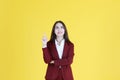 Business Caucasian woman in red suit smiling and thinking for good idea isolated on yellow background Royalty Free Stock Photo