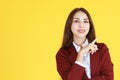 Business Caucasian woman in red suit smiling and thinking for good idea on yellow background Royalty Free Stock Photo