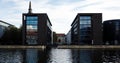 BUSiNESS CENTER IN COPENHAGEN, DENMARK. Row of modern buildings near the river Royalty Free Stock Photo