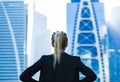 Business challenge. Confident businesswoman overlooking the city center high-rises