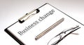 BUSINESS CHANGE Concept on white sheet with pen and glasses Royalty Free Stock Photo