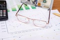 Business chart and eyeglasses, dollar, calculator, pen Royalty Free Stock Photo