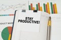 On the business charts is a notepad with the inscription - Stay Productive Royalty Free Stock Photo