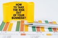 On the business charts are a pen and a paper plate with the inscription - How To Take the Risk Out of Your Business