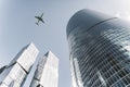 Business city center buildings with flight plane background. Modern office architecture in the financial district. Glass Royalty Free Stock Photo