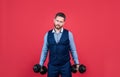 Business coach in formal style lift hand weights setting powerful goal red background, motivation Royalty Free Stock Photo