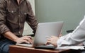 Business colleague working on report documents with laptop at a workplace Royalty Free Stock Photo