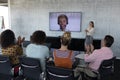 Business colleagues applauding while attending a video call in a conference room Royalty Free Stock Photo