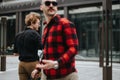 Business colleagues in casual attire having an informal meeting outside a modern office building Royalty Free Stock Photo