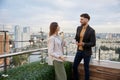 Business colleagues chitchatting during coffee break at office roof terrace Royalty Free Stock Photo