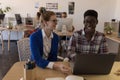 Business colleagues discussing over laptop in office Royalty Free Stock Photo