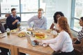 Business colleagues discussing while sitting around breakfast table Royalty Free Stock Photo