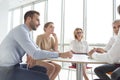 Business colleagues discussing while sitting at table in new office Royalty Free Stock Photo