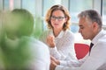 Business colleagues discussing while sitting at table in new office Royalty Free Stock Photo