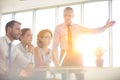 Business colleagues discussing at table in new office during meeting Royalty Free Stock Photo