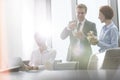 Business colleagues eating lunch in boardroom during meeting at office Royalty Free Stock Photo