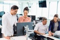 Business colleagues interacting with each other at desk in office Royalty Free Stock Photo