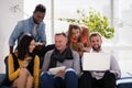 Business colleagues interacting with each other while using electronic devices Royalty Free Stock Photo