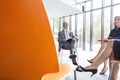 Business colleagues planning strategy while sitting on chairs during meeting Royalty Free Stock Photo