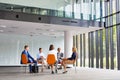 Business colleagues planning strategy while sitting on chairs during meeting Royalty Free Stock Photo