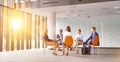 Business colleagues planning strategy while sitting on chairs during meeting