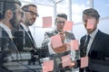 Business colleagues reading sticky notes on glass Royalty Free Stock Photo