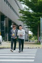 Business colleagues talking while walking in front of office building Royalty Free Stock Photo