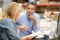 Business Colleagues Working At Desk In Warehouse Royalty Free Stock Photo