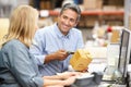 Business Colleagues Working At Desk In Warehouse Royalty Free Stock Photo