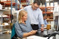 Business Colleagues Working At Desk In Warehouse Royalty Free Stock Photo