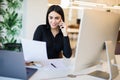 Business, communication and people concept. Happy businesswoman with laptop computer and papers calling on desk phone at office Royalty Free Stock Photo