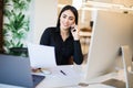 Business, communication and people concept. Happy businesswoman with laptop computer and papers calling on desk phone at office Royalty Free Stock Photo