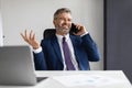 Business Communication. Smiling Mature Male Entrepreneur Talking On Cellphone In Office Royalty Free Stock Photo
