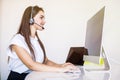 Business, communication, technology and call center concept - friendly female helpline operator with headphones and computer call Royalty Free Stock Photo