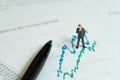 Business company profit, investment and financial report analysis concept, miniature people figurine success businessman standing