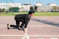 Business competition: businesswoman on start line and ready to reach the target Royalty Free Stock Photo