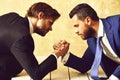 Business competition concept Businessmen arm wrestling in office Royalty Free Stock Photo