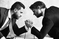 Business competition concept Businessmen arm wrestling in office Royalty Free Stock Photo