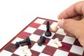 Hand holding chess piece and playing chess game. Royalty Free Stock Photo