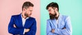 Business competition and confrontation. Business partners competitors in suits with tense bearded faces. Businessmen Royalty Free Stock Photo