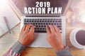 BUSINESS CONCEPT: 2019 ACTION PLAN with male hands using a lapt