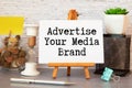 Business concept about Advertise Your Media Brand with sign on the piece of paper.