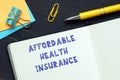 Business concept about AFFORDABLE HEALTH INSURANCE with phrase on the financial document