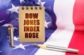 Against the background of the American flag is a notepad with the inscription - Dow Jones index rose Royalty Free Stock Photo