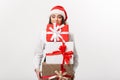 Business Concept - Beautiful young caucasian business woman with santa hat holding a lot of christmas gift boxes with Royalty Free Stock Photo