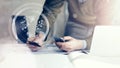 Business concept. Businessman holding hand businesscard and making photo smartphone. Architectural project on the table