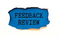 Business concept. Businessman holds a card with the text - FEEDBACK REVIEW