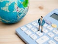 Business Concept. businessman small figures standing on calcula Royalty Free Stock Photo